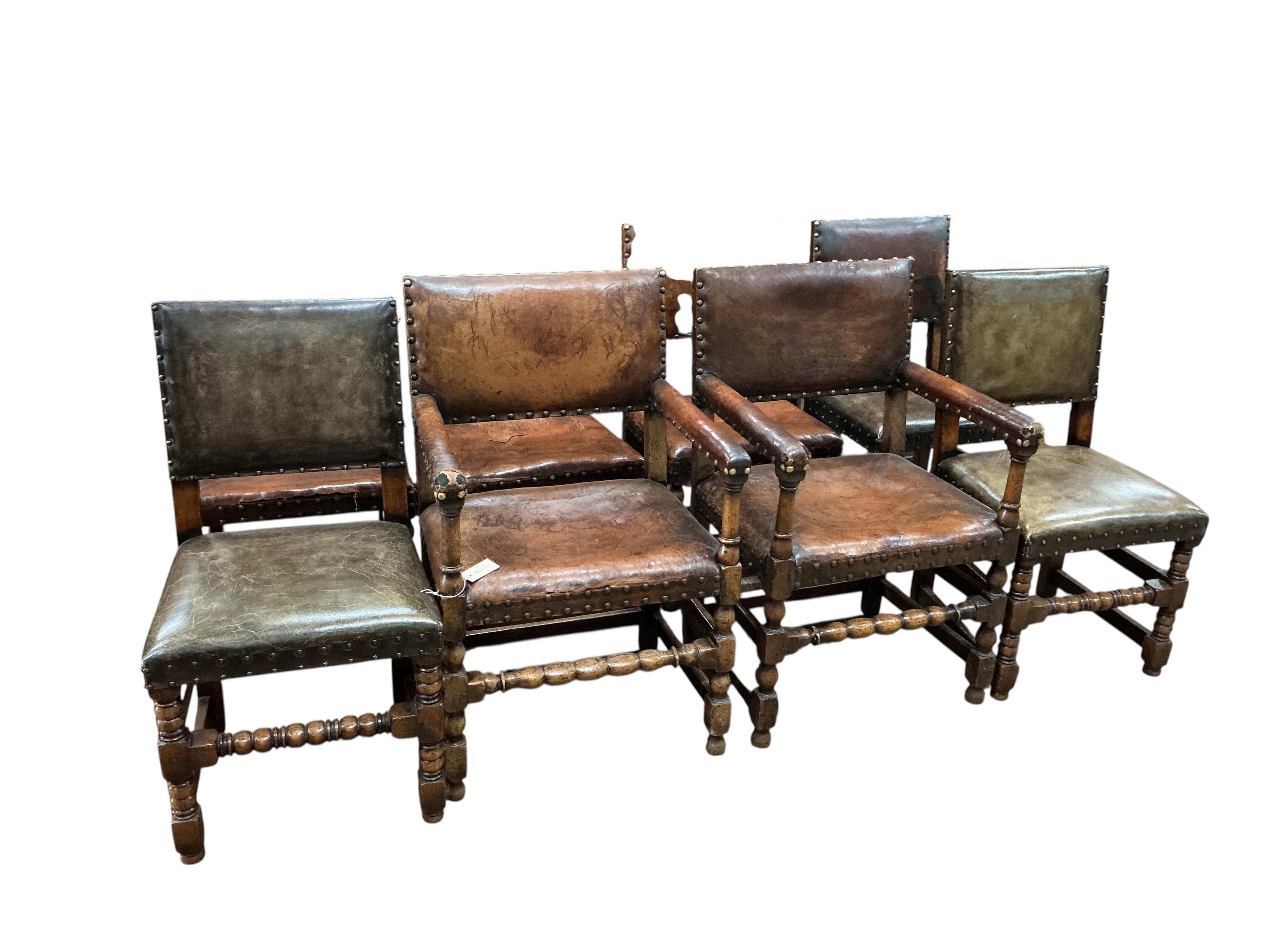 A set of eight Cromwellian style oak and tan leather dining chairs, two with arms